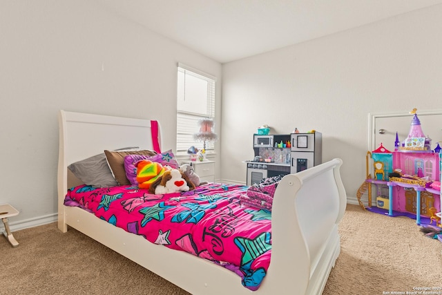 bedroom featuring carpet flooring and baseboards