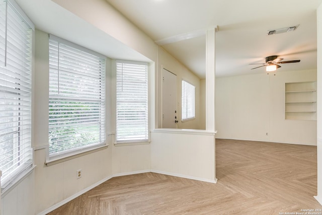7442 Castle Trail Dr, San Antonio, TX 78218 - unfurnished room featuring plenty of natural light, ceiling fan, built in shelves, and visible vents
