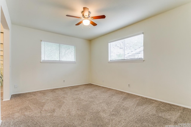 7442 Castle Trail Dr, San Antonio, TX 78218 - carpeted spare room featuring baseboards, ceiling fan, and a wealth of natural light