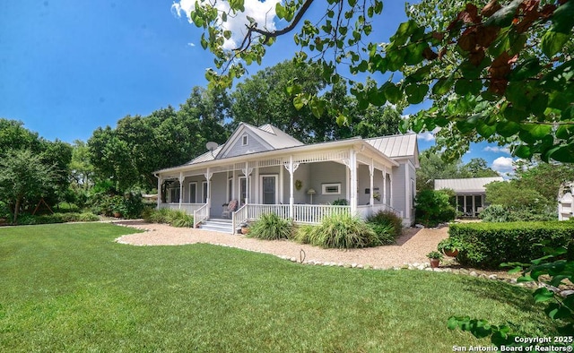 view of front of house with a porch, a front lawn, and metal roof