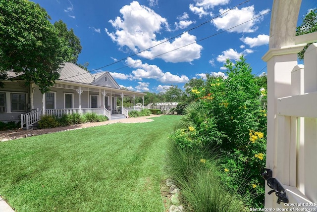 view of yard with covered porch