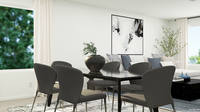 dining room featuring baseboards and light wood-type flooring