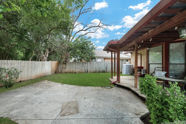view of yard with a patio, a fenced backyard, and a wooden deck