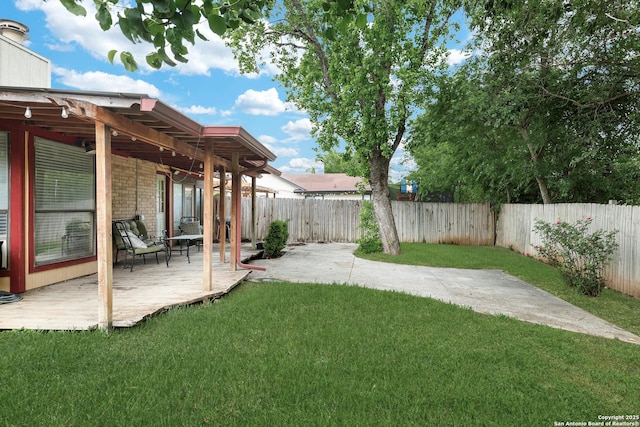 view of yard with a wooden deck and a fenced backyard