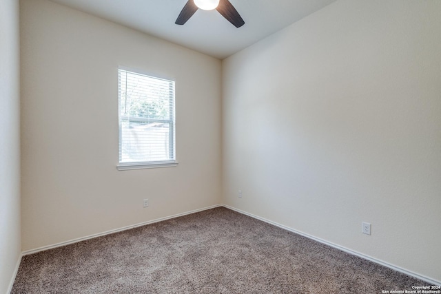 empty room with baseboards, ceiling fan, and carpet flooring