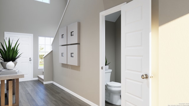 interior space with baseboards and dark wood-style floors