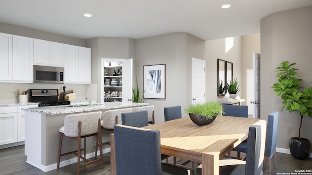 dining room with recessed lighting, baseboards, and dark wood-style flooring