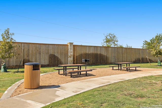 surrounding community with a lawn and fence