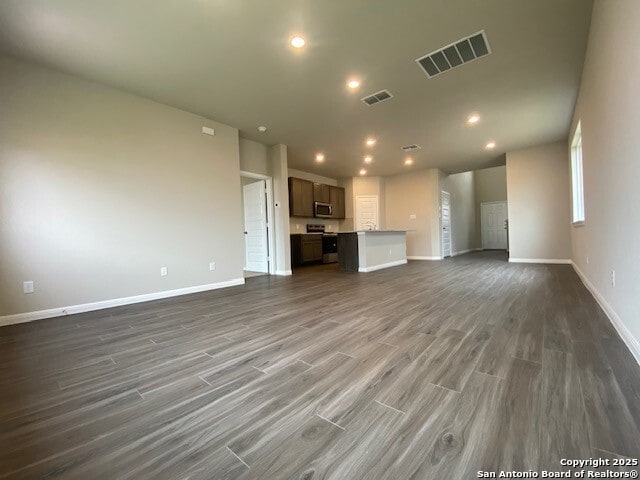 unfurnished living room featuring recessed lighting, baseboards, visible vents, and wood finished floors