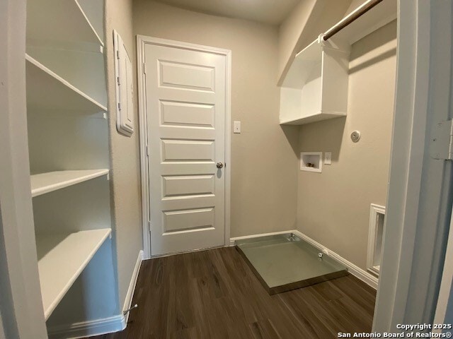 laundry area featuring laundry area, hookup for a washing machine, baseboards, and dark wood-type flooring
