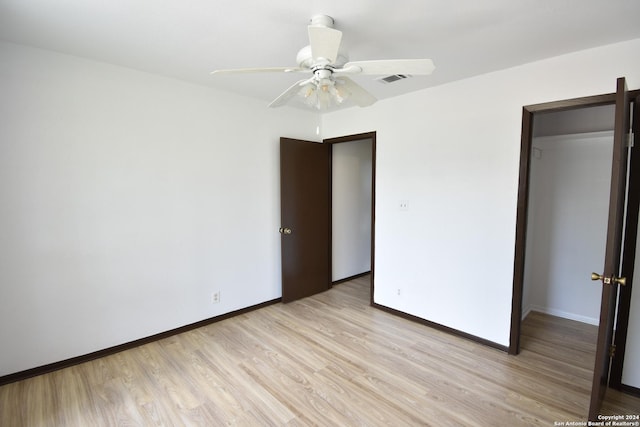 unfurnished bedroom with baseboards, ceiling fan, light wood-style flooring, and visible vents