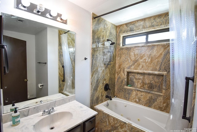 bathroom featuring a combined bath / shower with jetted tub and vanity