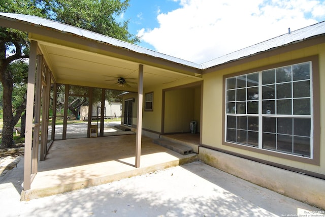 view of patio / terrace with a ceiling fan, an outdoor structure, and a storage unit