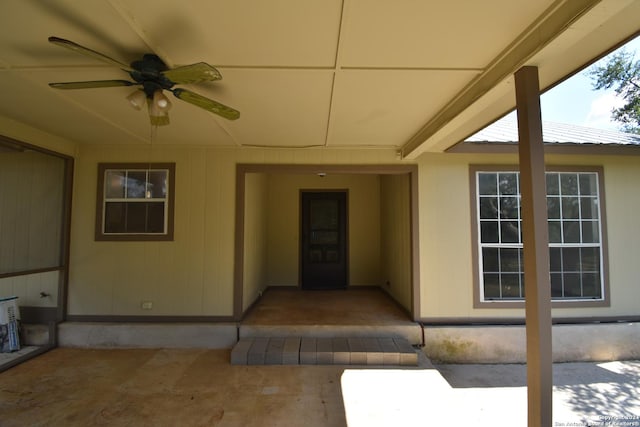 doorway to property featuring a ceiling fan and a patio area