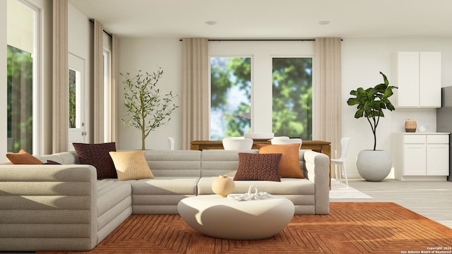 sitting room with plenty of natural light and light wood finished floors