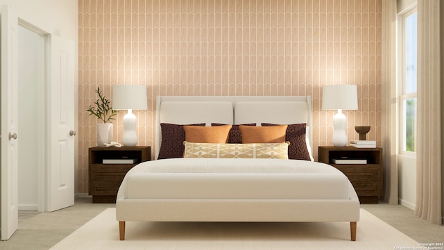 bedroom featuring baseboards and light carpet