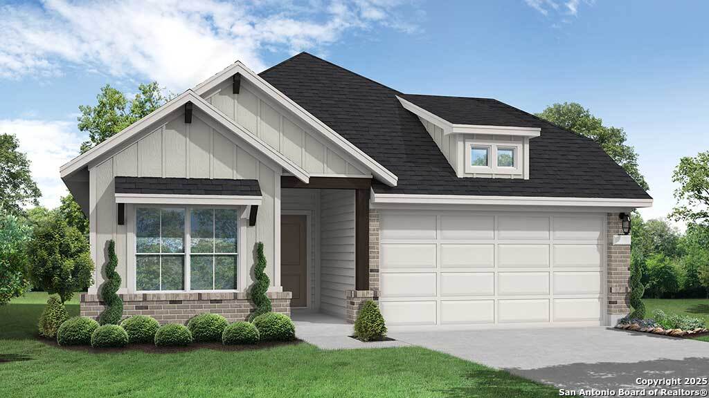 modern farmhouse style home featuring a front yard, brick siding, a shingled roof, an attached garage, and driveway