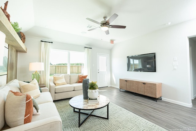 living room with a ceiling fan, baseboards, wood finished floors, lofted ceiling, and visible vents