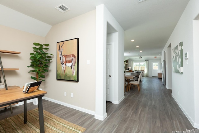 hallway featuring visible vents, recessed lighting, baseboards, and wood finished floors