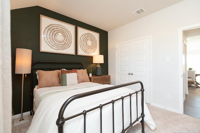 carpeted bedroom with baseboards and visible vents