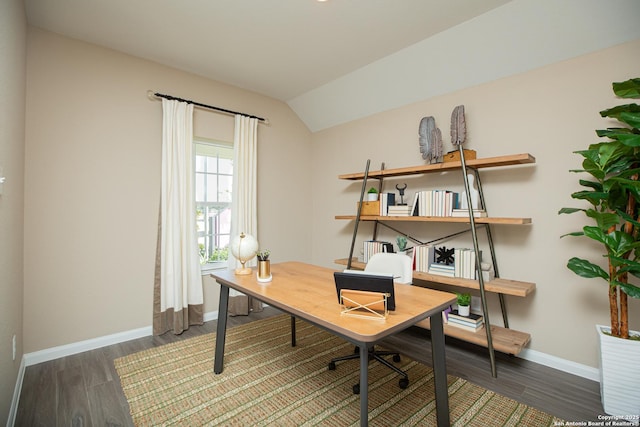 office space with baseboards, vaulted ceiling, and wood finished floors