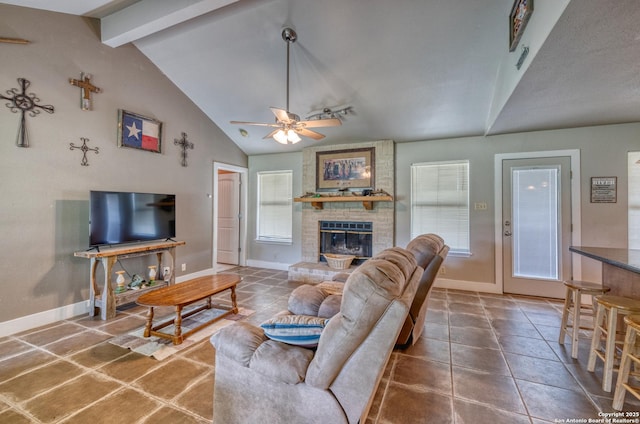 tiled living room with baseboards, ceiling fan, lofted ceiling with beams, and a brick fireplace