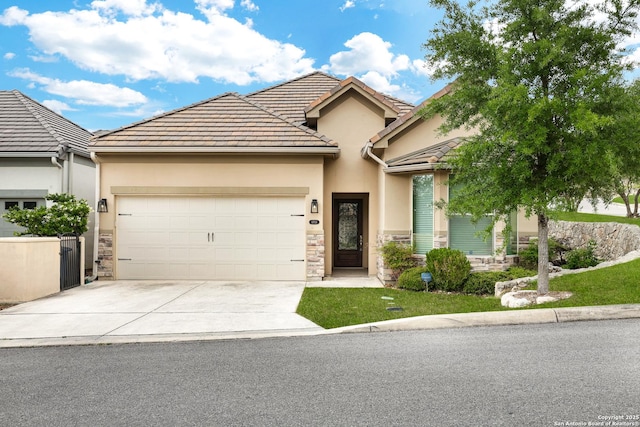 view of front of property featuring concrete driveway, a garage, stone siding, and stucco siding