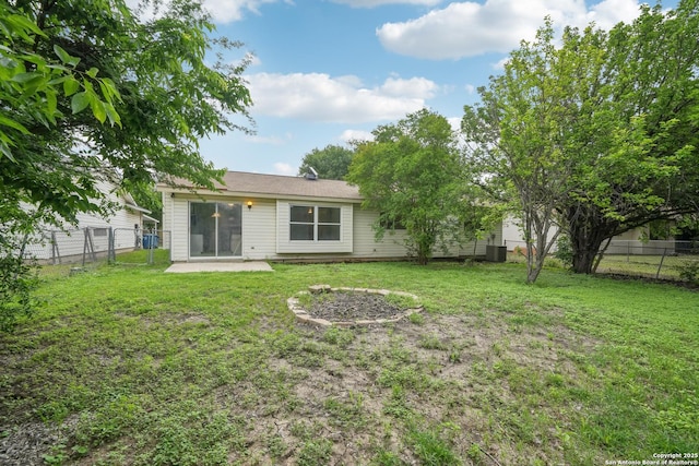 rear view of property featuring a fenced backyard, a yard, and a patio area
