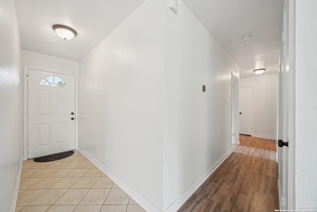 entryway featuring baseboards and light wood-type flooring