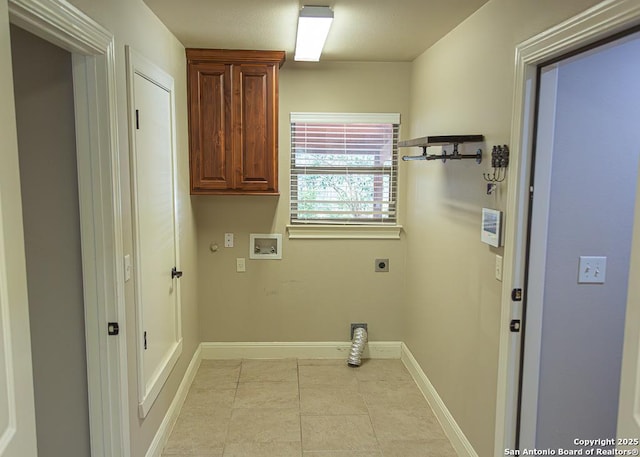 laundry area featuring hookup for an electric dryer, cabinet space, light tile patterned floors, baseboards, and hookup for a washing machine