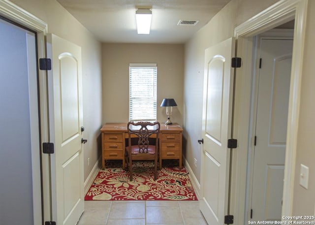 office space featuring visible vents, baseboards, and light tile patterned floors