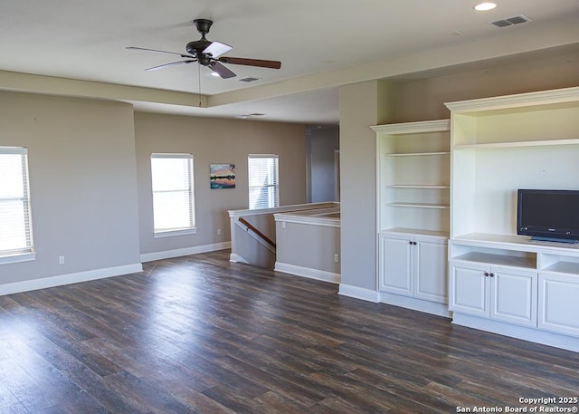 unfurnished living room featuring baseboards, a ceiling fan, dark wood-style flooring, and visible vents