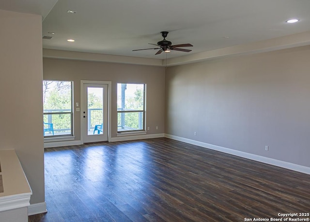 spare room featuring ceiling fan, recessed lighting, baseboards, visible vents, and dark wood-style floors
