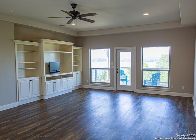 unfurnished living room featuring baseboards, plenty of natural light, and ceiling fan