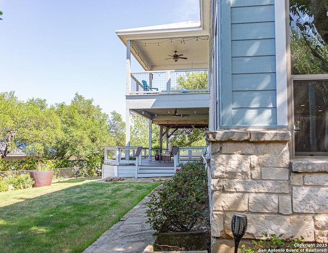 exterior space featuring fence and ceiling fan