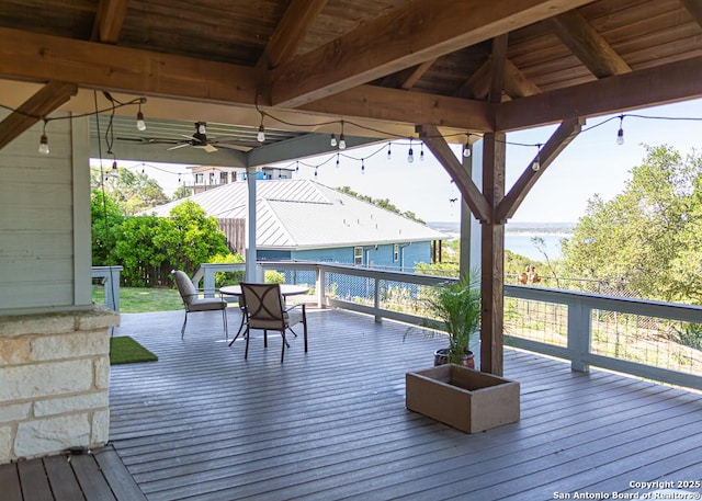 wooden terrace featuring a water view and a gazebo