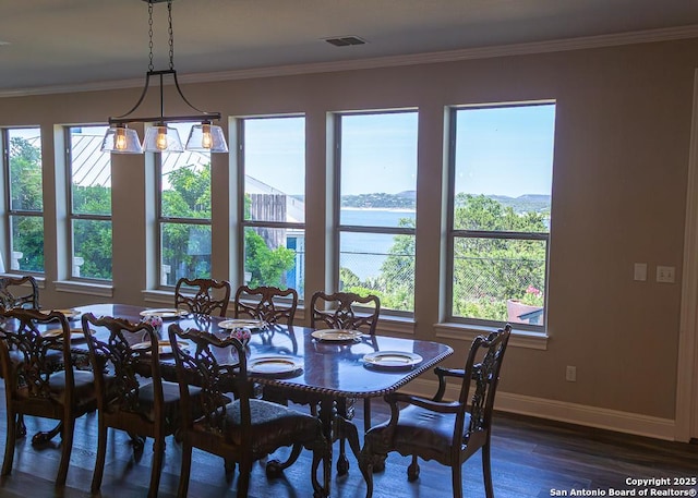 dining room featuring baseboards, visible vents, ornamental molding, and dark wood-type flooring