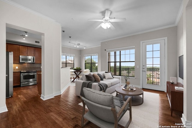 living area with crown molding, dark wood-style flooring, a ceiling fan, and visible vents
