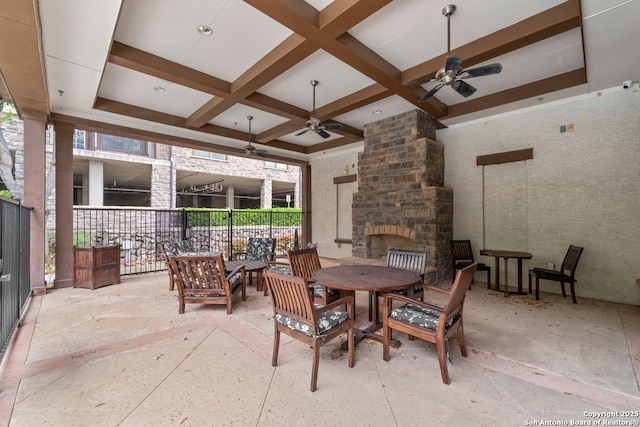 view of patio / terrace featuring ceiling fan, fence, and a fireplace