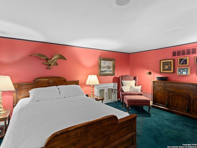 carpeted bedroom featuring visible vents