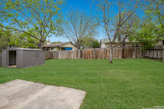 view of yard featuring a fenced backyard, a patio, an outdoor structure, and a shed