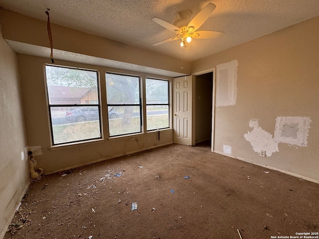 interior space featuring a ceiling fan and a textured ceiling