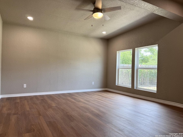 unfurnished room with baseboards, a textured ceiling, dark wood finished floors, and ceiling fan
