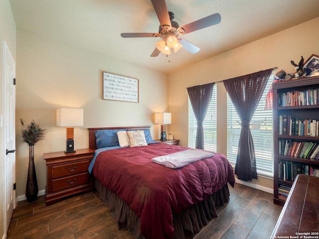 bedroom with baseboards, dark wood finished floors, and ceiling fan