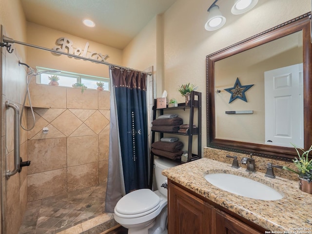 bathroom featuring vanity, a stall shower, and toilet