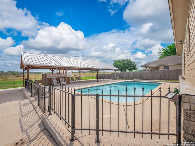 view of swimming pool with a fenced in pool, a patio area, fence, and a gazebo