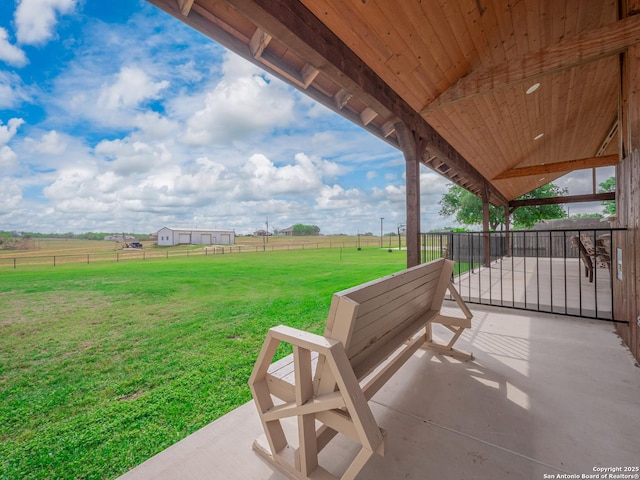 view of patio / terrace featuring fence and a rural view