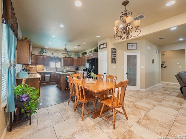 dining space with an inviting chandelier, baseboards, recessed lighting, and visible vents