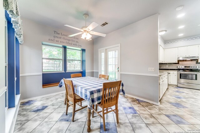 dining room featuring light tile patterned floors, baseboards, ceiling fan, and visible vents