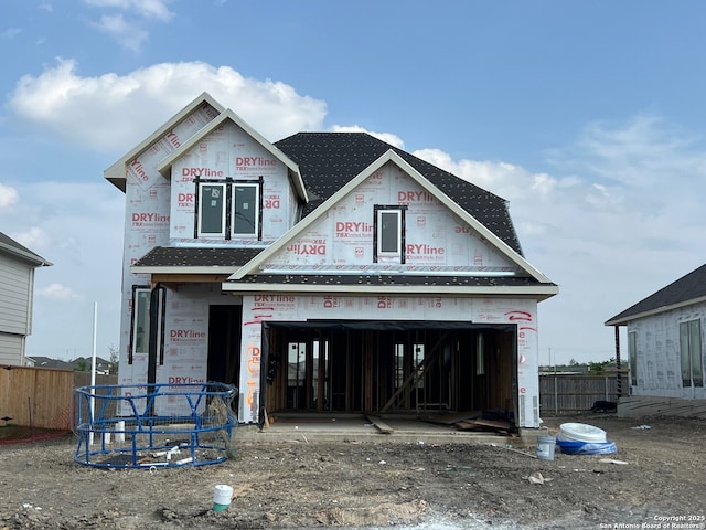 property under construction with fence and a garage
